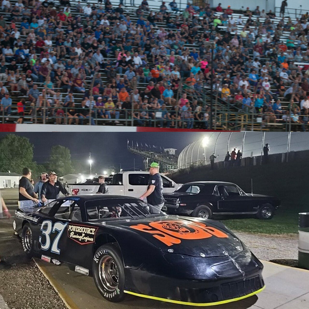 A race car with number 37 and Power Source branding is parked near a track at night. Several people stand nearby. In the background, a grandstand is filled with spectators.