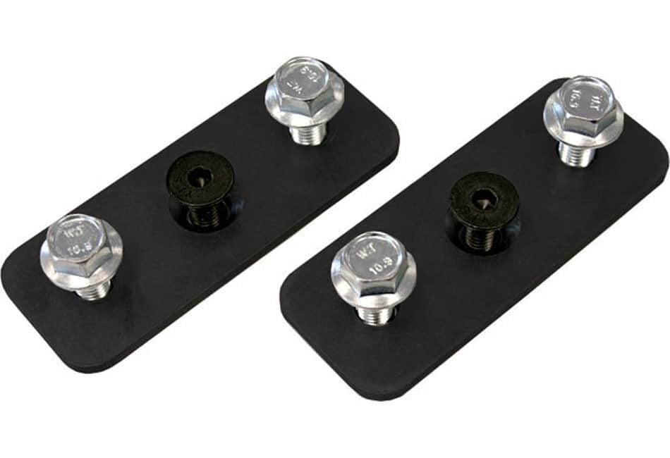 Two black rectangular metal plates, each with three boltsâ€”two silver and one blackâ€”arranged in a row on top of the plates. The plates are placed on a white background.