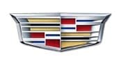 A metallic Cadillac logo featuring a silver shield with horizontal stripes in gold, red, blue, and black, divided into geometric sections.